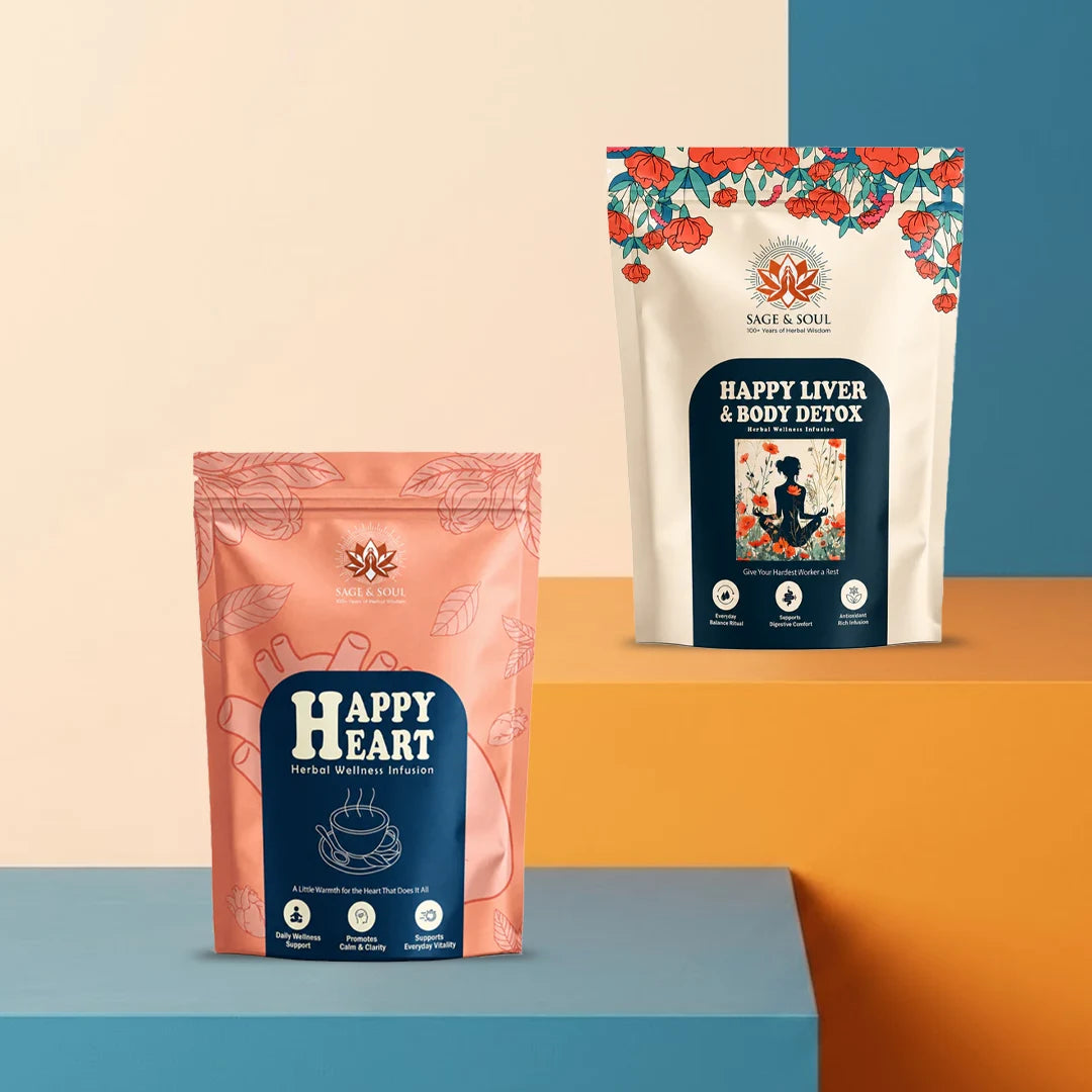 Two stand-up pouches of Sage & Soul herbal supplements displayed on a geometric studio background. The front pouch is peach-pink with a dark blue label reading 'Happy Heart' and the back pouch is white with a floral border and a dark blue label reading 'Happy Liver & Body Detox'.