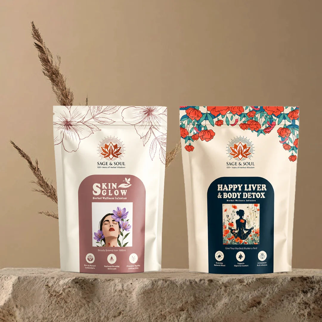 Two stand-up pouches of Sage & Soul herbal supplements, 'Skin Glow' and 'Happy Liver & Body Detox', displayed side-by-side on a rustic stone surface with dried grass against a beige background.