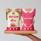 Two packages of 'Rosy Glow' and 'Lady Bloom' on a wooden tray against a gray background